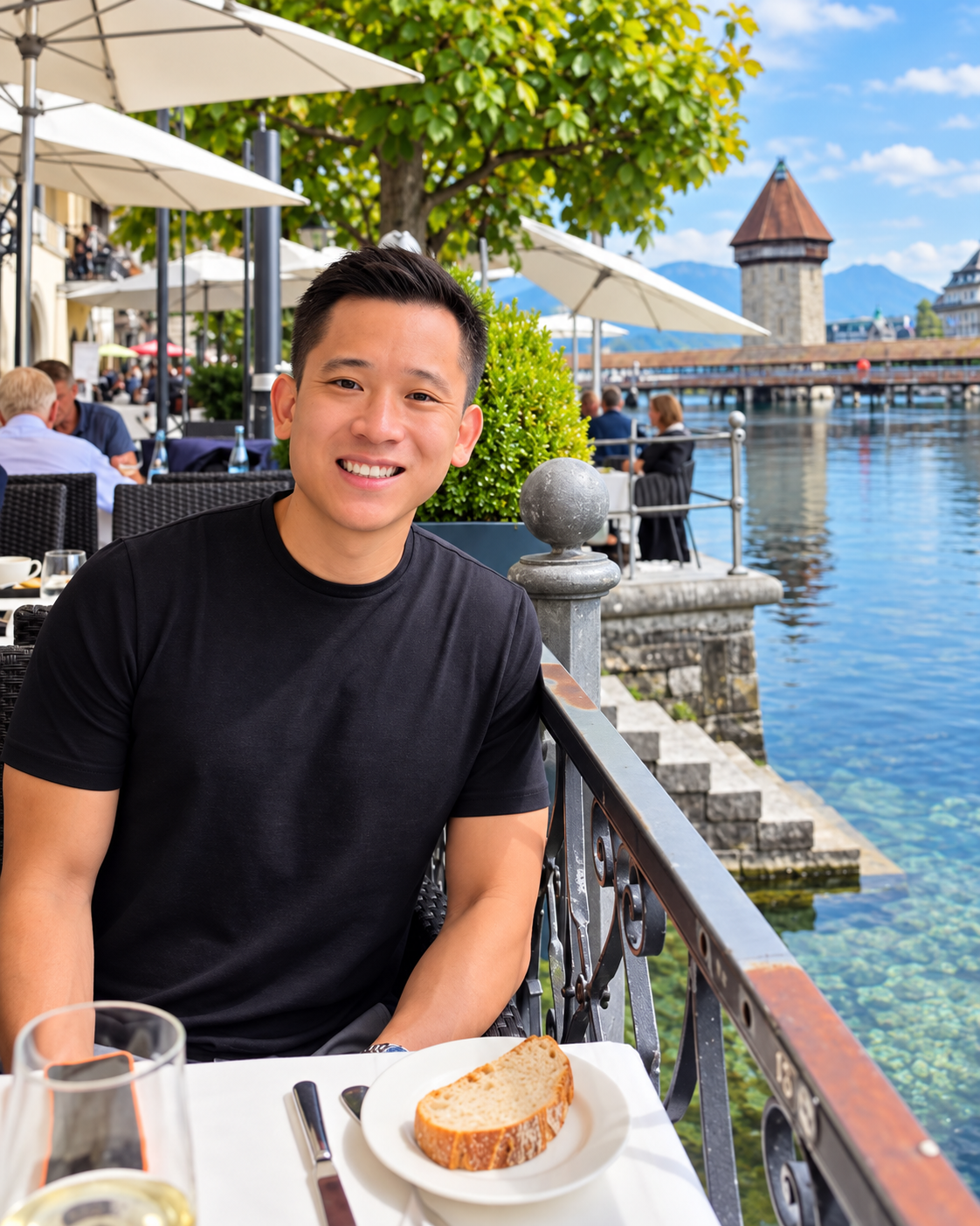 Corey smiling at a waterfront restaurant